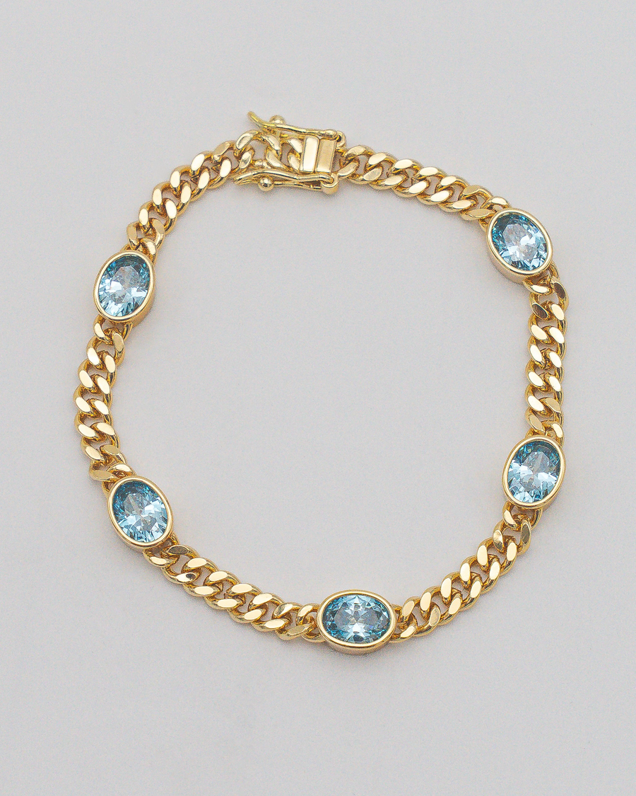 Goldenes Panzerarmband mit hellblauen Steinen