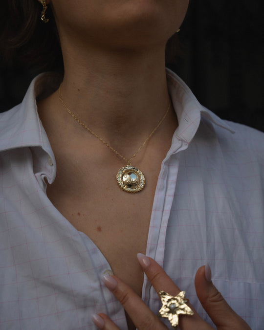 Champagne Necklace Gold — pendant close-up, worn with a white shirt